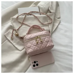 Pink quilted chain vanity bag with top handle and crossbody strap for stylish women.