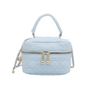Light blue quilted cosmetic vanity bag with chain strap and top handle for women stylish daily use