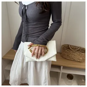 Elegant white evening clutch bag with unique gold metallic handle for women's fashion wear.