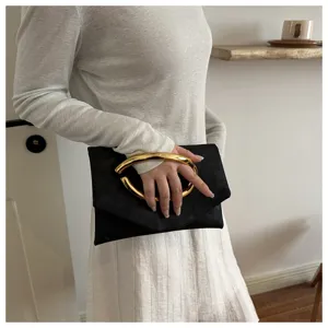 Elegant black envelope clutch bag featuring a statement chunky gold metal ring handle.