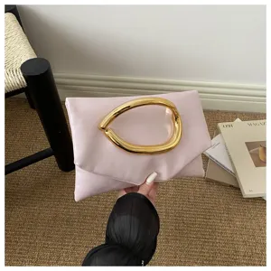 Chic pink clutch bag with unique gold metal handle, elegant evening party and casual purse.