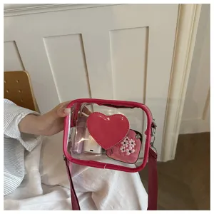 Sac bandoulière transparent avec bordure rose et cœur, style décontracté pour femmes.