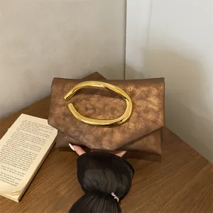 Elegant brown leather evening clutch bag with luxury golden curved handle for women fashion