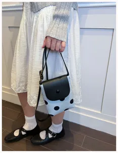 Detailed view of the stylish contrast color polka dot mini shoulder bag, perfect for summer.