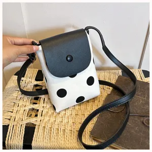 Chic black and white polka dot canvas crossbody bag with sleek leather flap for women.