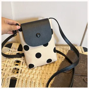 Canvas polka dot crossbody phone bag detail, stylish contrast shoulder bag with black flap.