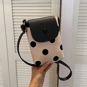 Chic polka dot canvas crossbody bag for women, stylish contrast color phone shoulder bag.