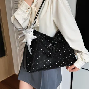 Black polka dot tote bag detail, featuring a cute lace star pendant for daily commute.