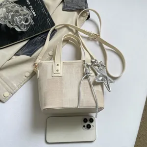 Chic canvas bucket bag with shoulder strap and star charm, perfect versatile daily accessory for women.