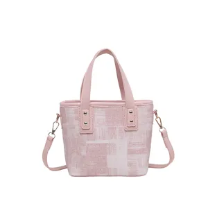 Chic pink textured bucket bag, versatile shoulder crossbody handbag with top handles.
