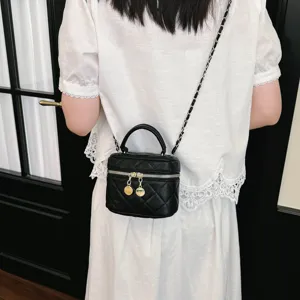 Detailed view of the black quilted crossbody cosmetic bag with chain strap and chic design.
