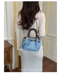 Retro denim bucket handbag for women, casual stylish shoulder bag with top handles and cute charm.