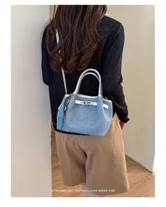 Vintage denim shoulder handbag for women, casual minimalist crossbody bag with silver hardware.
