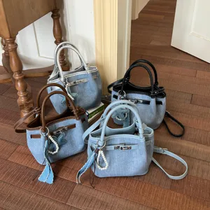 Detail view of retro denim bucket bags in multiple handle colors, casual style set display.