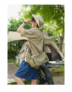 Borsa a tracolla cilindrica in tela casual, spazioso stile crossbody sportivo chic.
