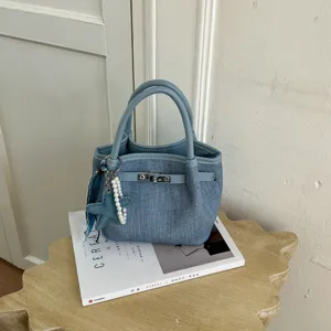 Retro denim handbag for women, large capacity casual stylish shoulder bag with charm.