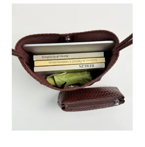 Dark brown woven shoulder bag with large capacity, chic leather bucket bag for daily use.