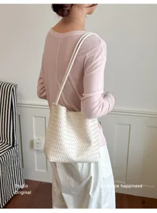 Woven leather shoulder bag for women, chic minimalist underarm bag for daily stylish look.