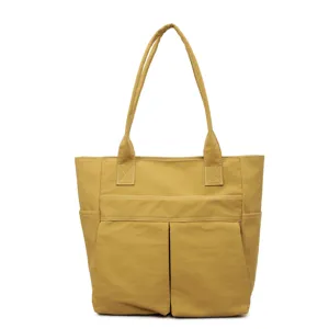 Spaziosa borsa tote gialla in tela da donna, borsa a spalla casual con tasche anteriori multiple.