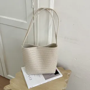 Vintage woven shoulder bag for women, chic minimalist bucket style PU leather handbag daily.