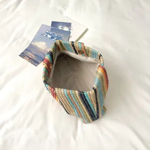 Colorful woven clutch bag detail shot, summer beach straw bag interior view, chic design.