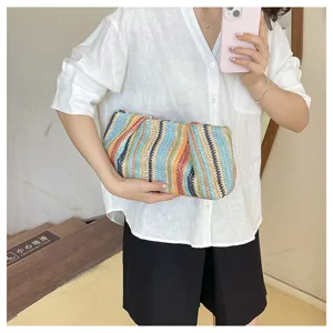 Detail view of the colorful straw woven clutch, ideal for summer beach and casual daily outfits.