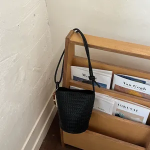 Black woven bucket bag for women, retro style shoulder crossbody bag for summer chic look.