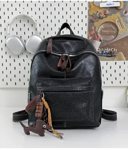 Retro black leather backpack with croc-embossed front pocket for daily commute and school travel.