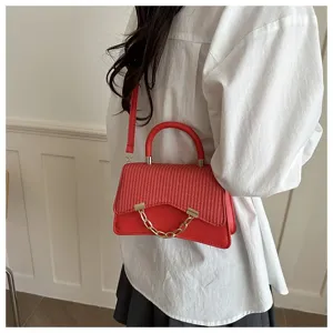 Red crossbody shoulder bag for women, stylish woven flap design with top handle and gold chain.