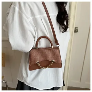 Detailed view of women fashion brown woven shoulder crossbody bag with metal chain.
