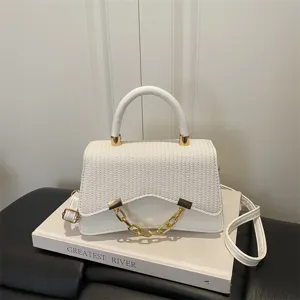 Trendy white women shoulder handbag with woven texture and gold chain for daily fashion style.