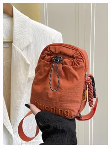 Orange casual mini crossbody bag for women, simple stylish nylon shoulder phone bag.