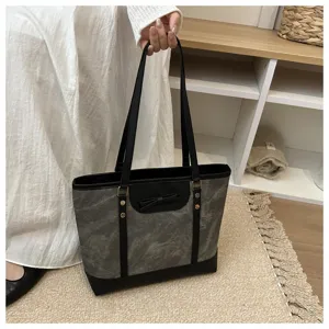 Casual large capacity tote bag detail view showing black grey texture and bow accent.