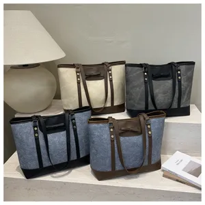 Detailed view of stylish large capacity commuter tote bags with bow decoration and leather trim.