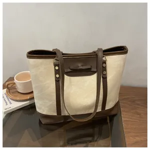 Canvas tote bag for women, stylish commuter shoulder bag with bow decor, large capacity.