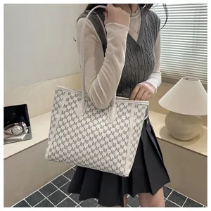Detailed view of the stylish large shoulder tote bag with M monogram pattern design.