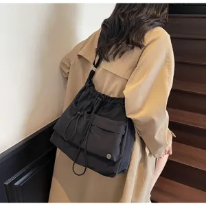 Detailed view of the black drawstring shoulder bag, casual messenger and stylish daily tote.