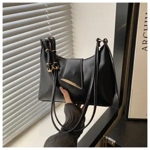 Detailed view of the stylish black underarm baguette bag, chic shoulder handbag for women.