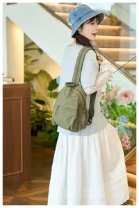 Detail view of the lightweight nylon backpack showcasing front pocket and comfortable shoulder straps.