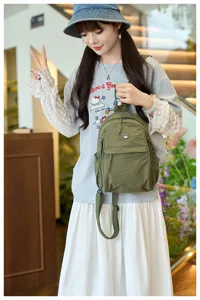 Close-up detail shot of the green nylon fashion backpack, showcasing daily casual wear style.