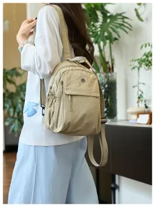 Detail view of casual women nylon backpack in khaki, featuring multi-pocket practical design.