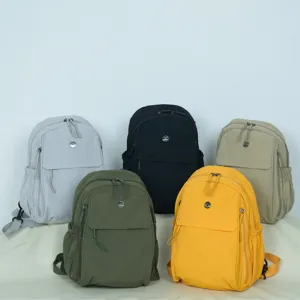Close-up detail of multi-color lightweight nylon backpacks displayed neatly for daily wear.