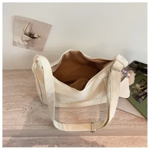 Detail view of the large capacity cream shoulder tote bag, relaxed style casual design for commute.