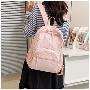 Detailed view of the casual pink women's backpack, featuring multi-pocket design and daily use.