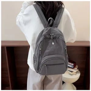 Casual grey women's backpack with multiple zipper pockets for daily school and travel.