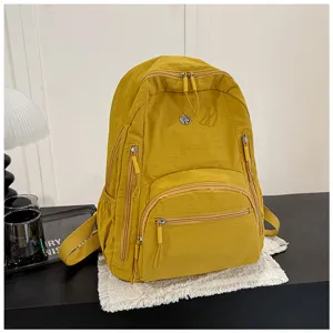 Stylish minimalist solid color nylon backpack with multiple zipper pockets for daily casual use.