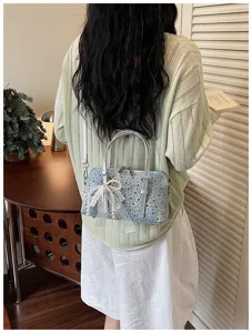 Stylish denim bowling handbag with rhinestones and lace bow, chic crossbody pillow bag for women.