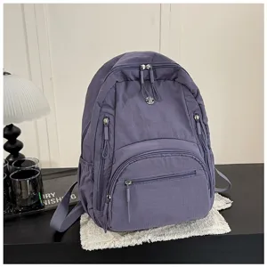 Stylish solid color nylon casual backpack for women with large capacity and multiple zipper pockets.