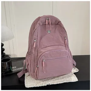 Detailed view of stylish minimalist backpack featuring durable nylon fabric and roomy pockets.