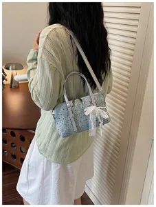 Stylish denim rhinestone bowling shoulder bag detail with white lace bow for daily use.